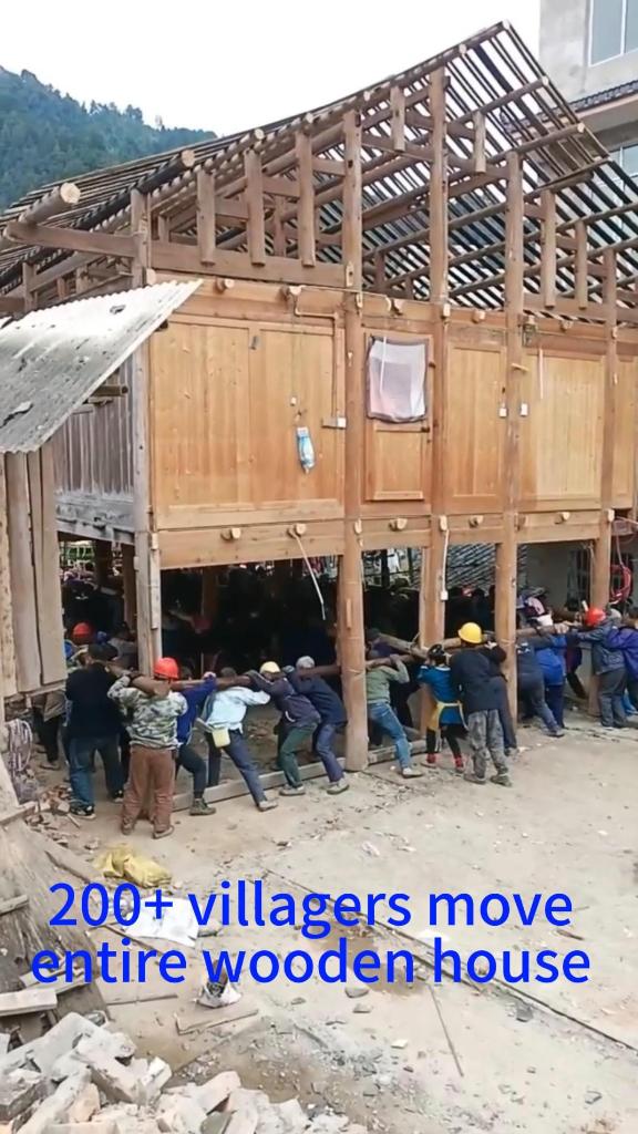 Over 200 villagers help move entire wooden house in SW China's Guizhou
