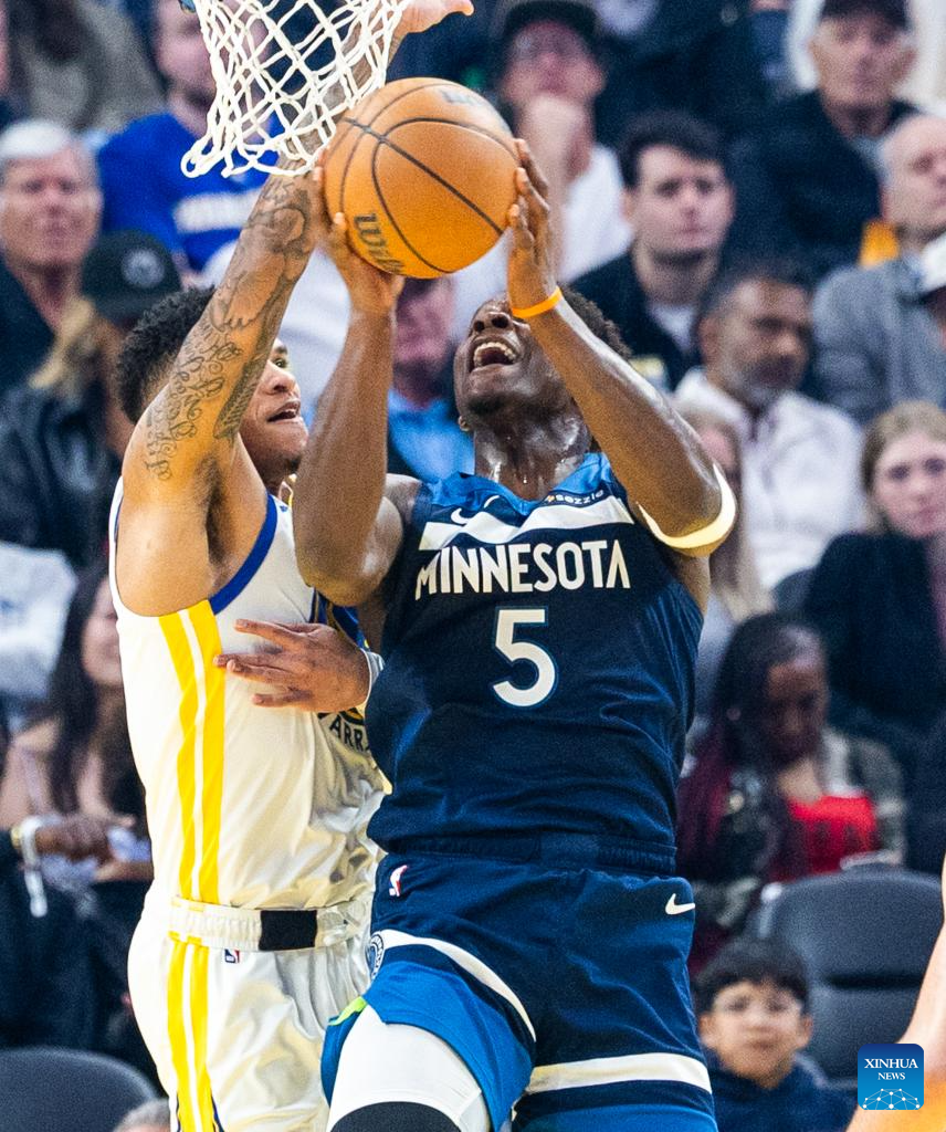 Minnesota Timberwolves' Anthony Edwards (R) goes to basket during the 2025-2026 NBA regular season basketball game between Minnesota Timberwolves and Golden State Warriors in San Francisco, the United States, March 13, 2026. (Photo by Dong Xudong/Xinhua)