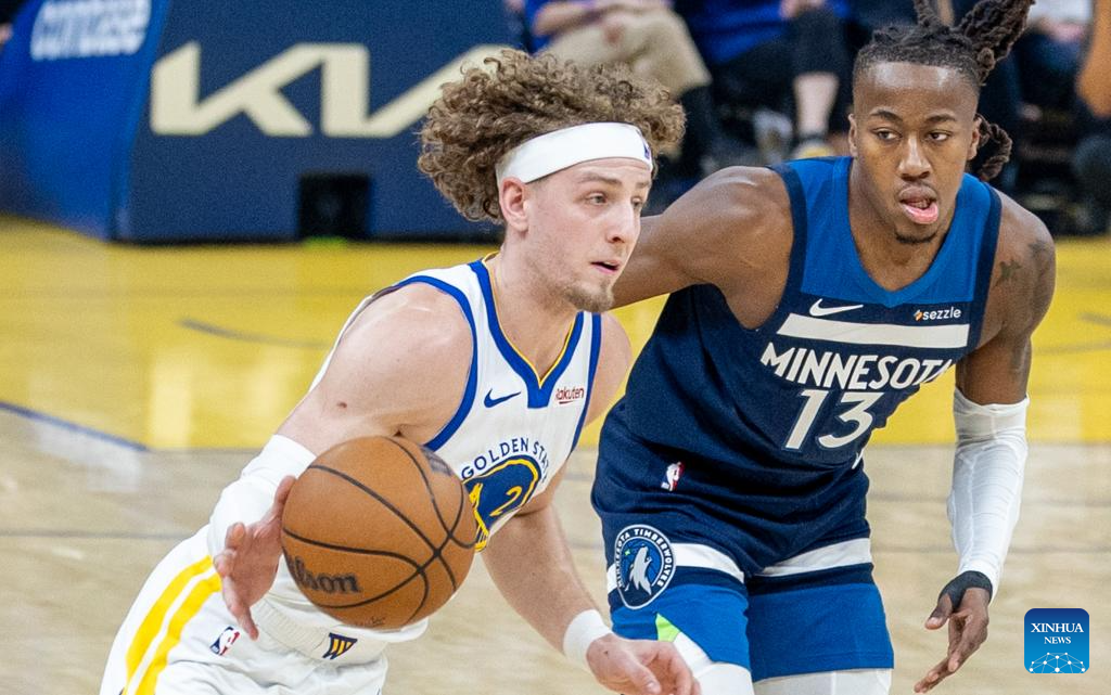 Golden State Warriors' Brandin Podziemski (L) dribbles the ball during the 2025-2026 NBA regular season basketball game between Minnesota Timberwolves and Golden State Warriors in San Francisco, the United States, March 13, 2026. (Photo by Dong Xudong/Xinhua)
