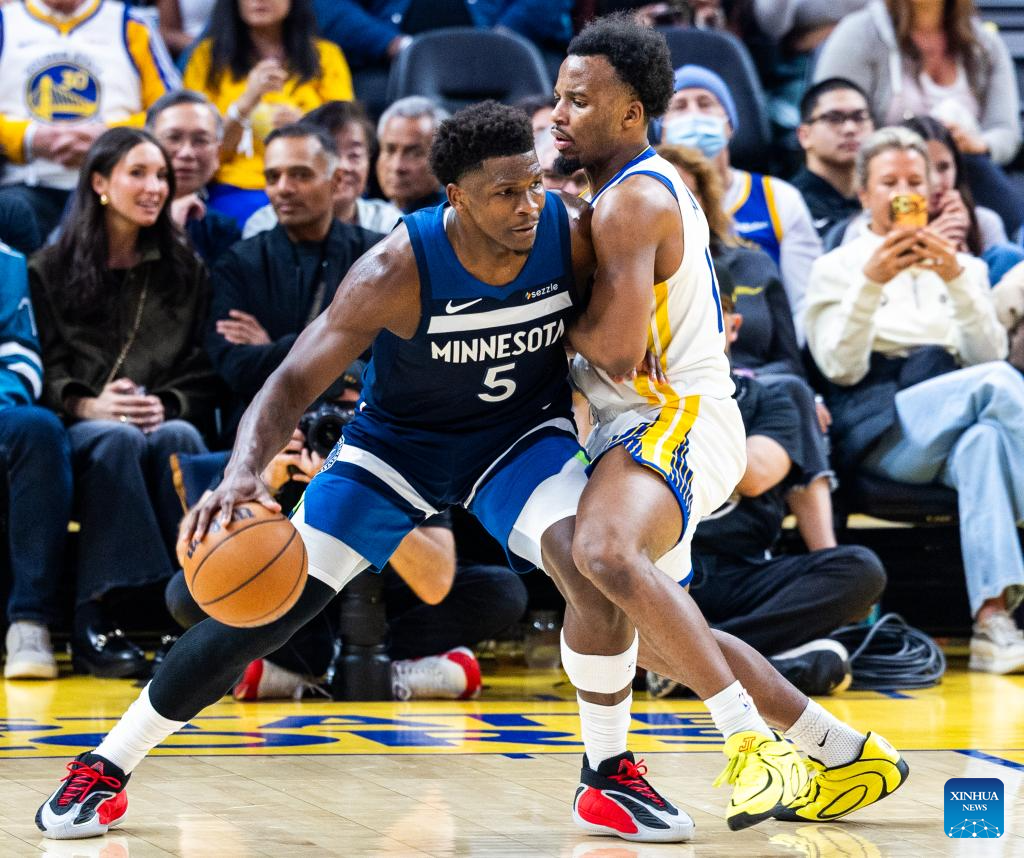Minnesota Timberwolves' Anthony Edwards (L) dribbles during the 2025-2026 NBA regular season basketball game between Minnesota Timberwolves and Golden State Warriors in San Francisco, the United States, March 13, 2026. (Photo by Dong Xudong/Xinhua)