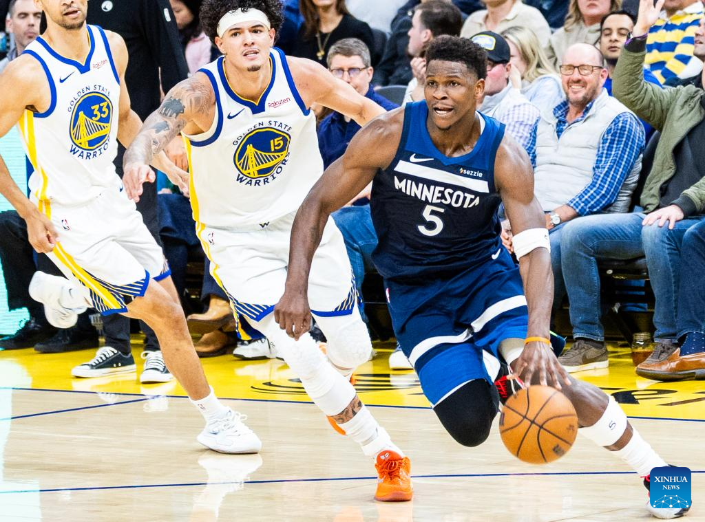 Minnesota Timberwolves' Anthony Edwards (R) dribbles during the 2025-2026 NBA regular season basketball game between Minnesota Timberwolves and Golden State Warriors in San Francisco, the United States, March 13, 2026. (Photo by Dong Xudong/Xinhua)