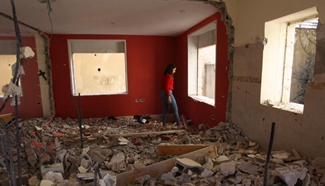 Palestinians inspect house destroyed by Israeli army in Birzeit