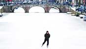 People enjoy skating on frozen canal in Netherlands