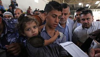 Palestinians wait for travel permit to cross into Egypt