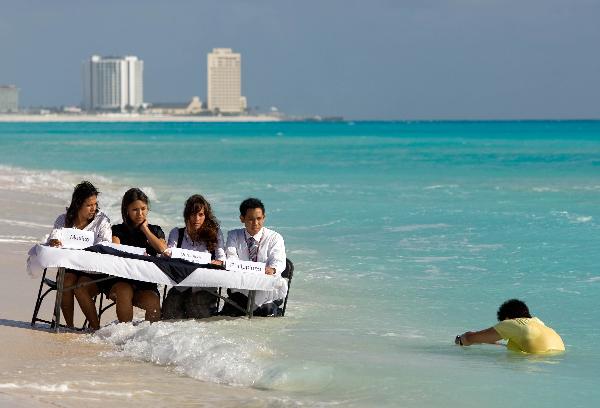 Activists hold meeting at partial-submerged table in Cancun