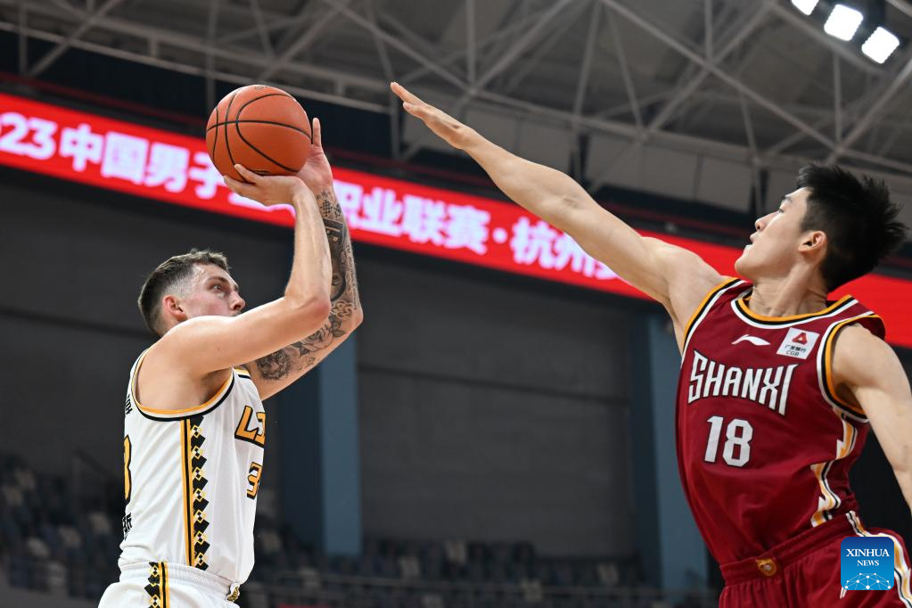 Qingdao(Shandong. 20th July, 2020. Ren Junwei (L) of Shanxi Loongs is  defended by Yang Jinmeng of Qingdao Eagles during a match between Shanxi  Loongs and Qingdao Eagles at the 2019-2020 Chinese Basketball