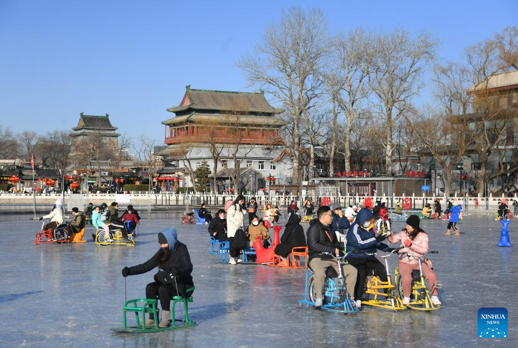 People play on frozen Shichahai lake in Beijing Xinhua