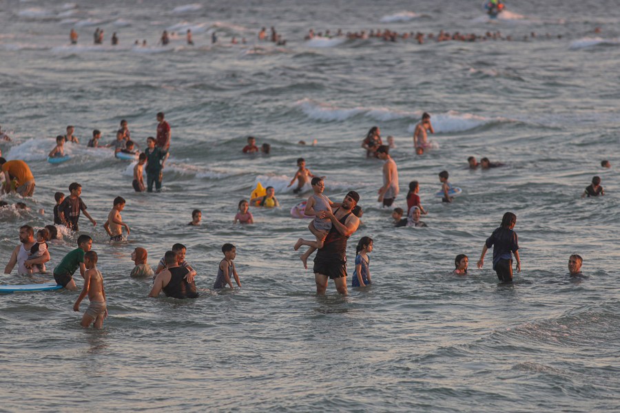 Mideast in Pictures: Gazan people cool off at seaside amid