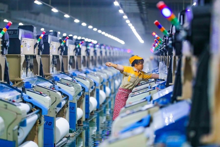 A worker is seen busy on the production line at a textile workshop in Hengli ‌(Luzhou) ⁣Industrial Park‌ in luzhou City, southwest china's Sichuan Province, Dec. 24, 2024. (Photo by Mu Ke/Xinhua) ‍