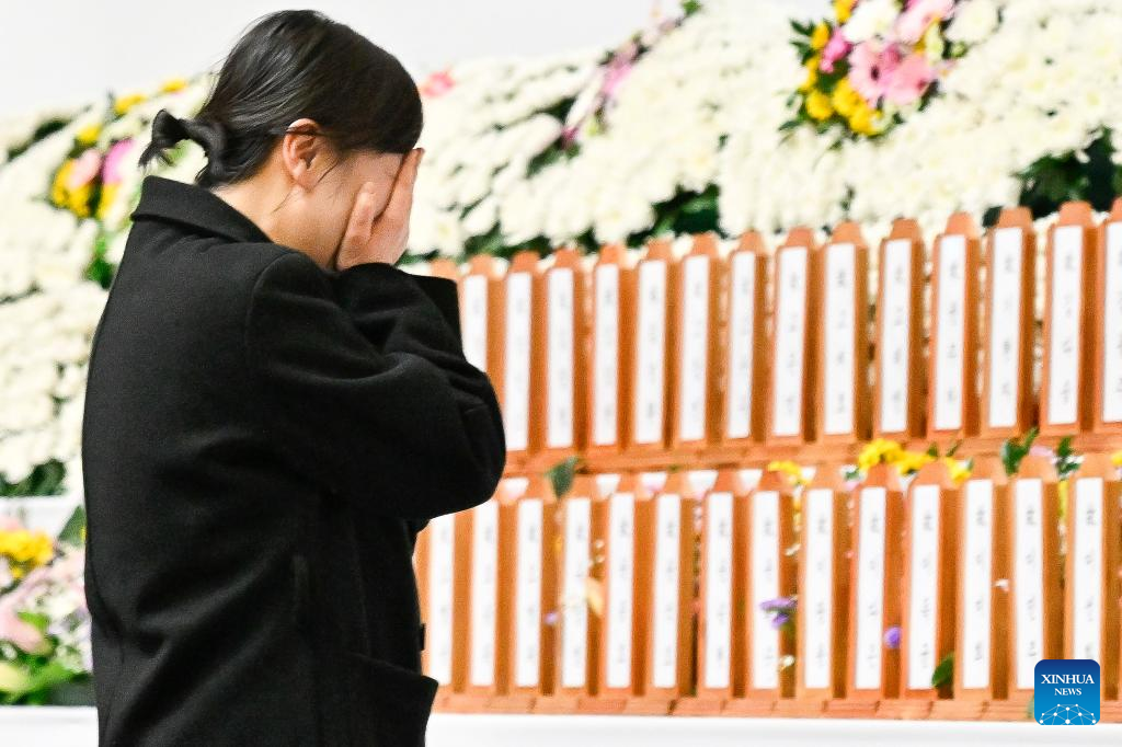 A bereaved family member pays tribute at a joint memorial altar for the victims of the Jeju Air plane crash in Muan, southwest South Korea, Dec. 30,‍ 2024.