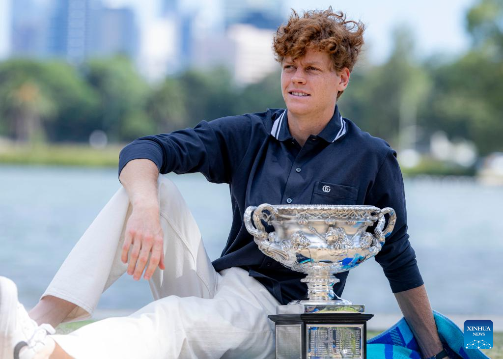 Jannik Sinner poses with trophy during Australian Open winner photo