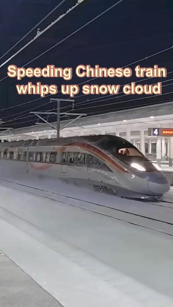 Speeding Chinese train whips up snow cloud
