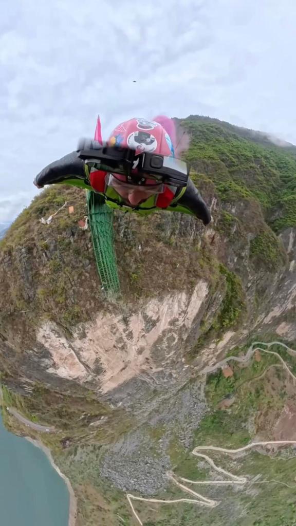 Immersive view of wingsuit flyers soaring through the skies of Yunnan