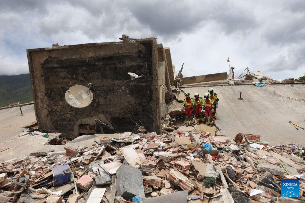 Rescuers work on a collapsed building in Playa Grande, La Guaira state, Venezuela, June 28, 2026