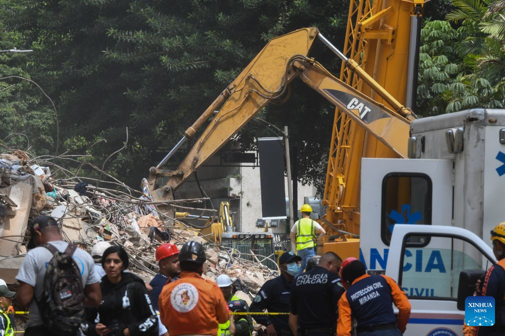 An excavator works on a collapsed building in Chacao, Venezuela, on June 28, 2026