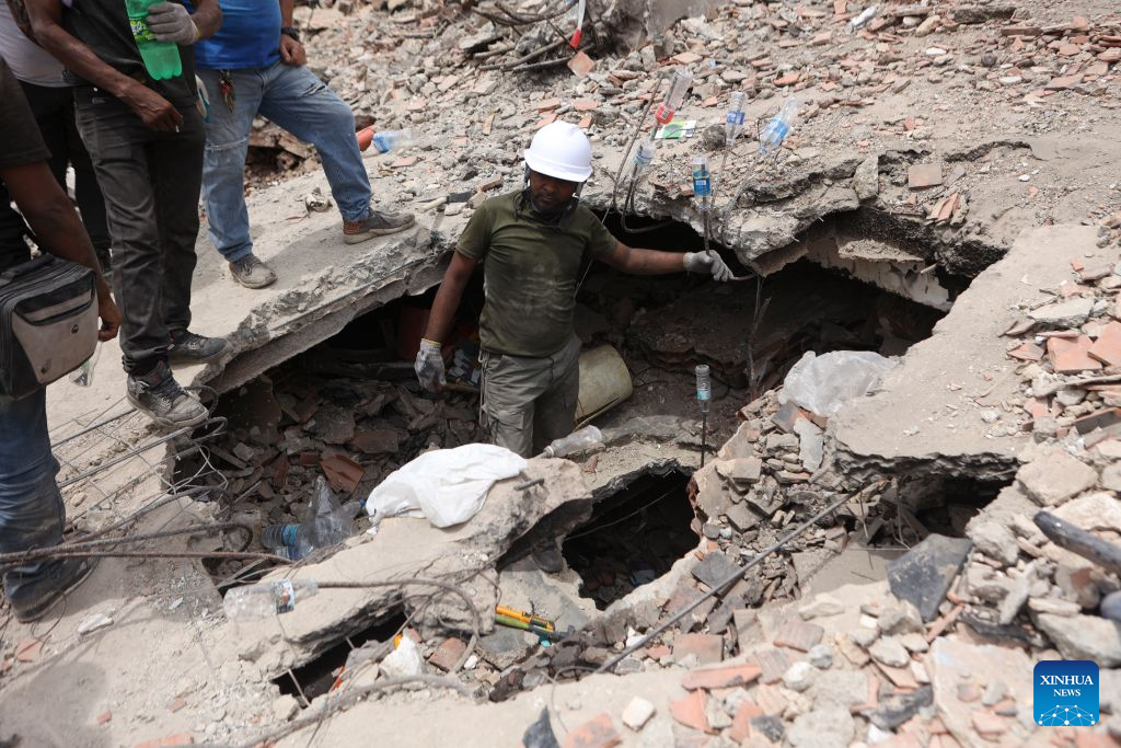 Rescuers work on a collapsed building in Playa Grande, La Guaira state, Venezuela, June 28, 2026