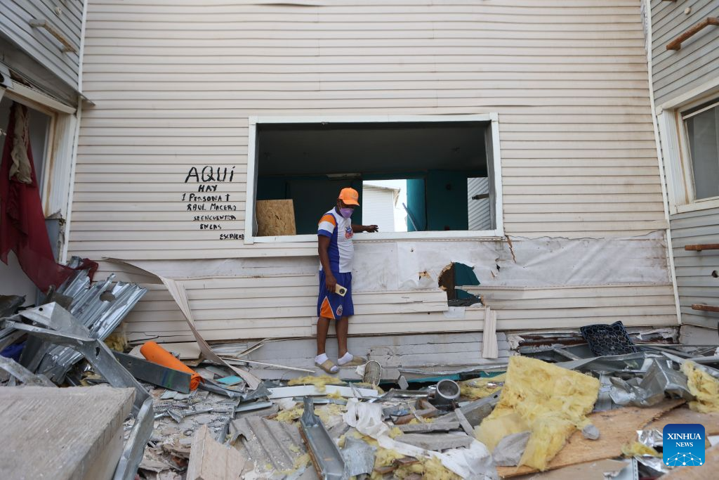 A man inspects a damaged building after earthquakes in Playa Grande, La Guaira state, Venezuela, June 28, 2026