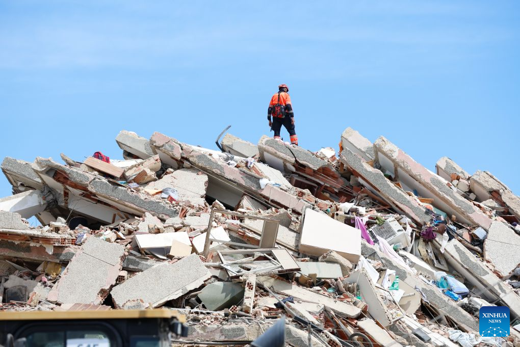 A rescuer stands on the rubble of a collapsed building in Caraballeda, La Guaira state, Venezuela, June 28, 2026