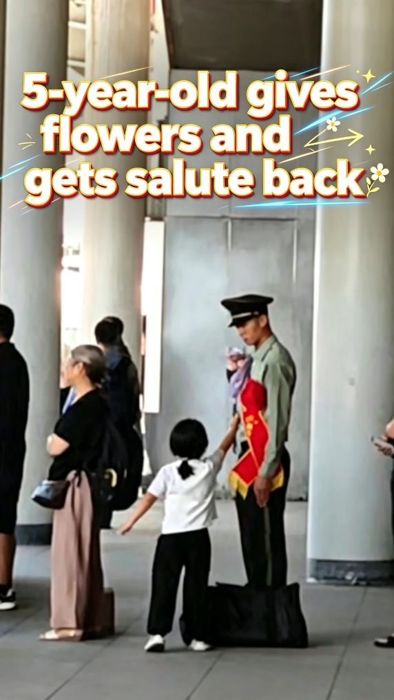 5-year-old gives flowers and gets salute back