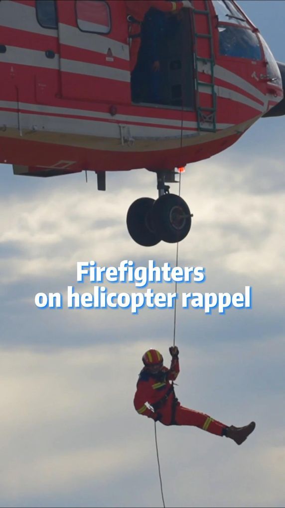 Firefighters on helicopter rappel
