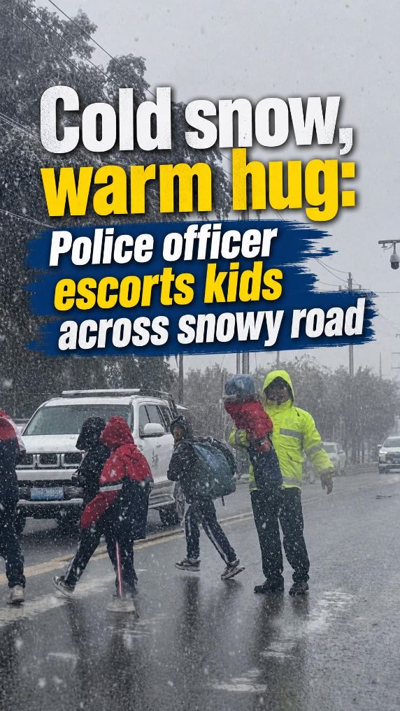 Cold snow, warm hug: Police officer escorts kids across road in Xinjiang, China
