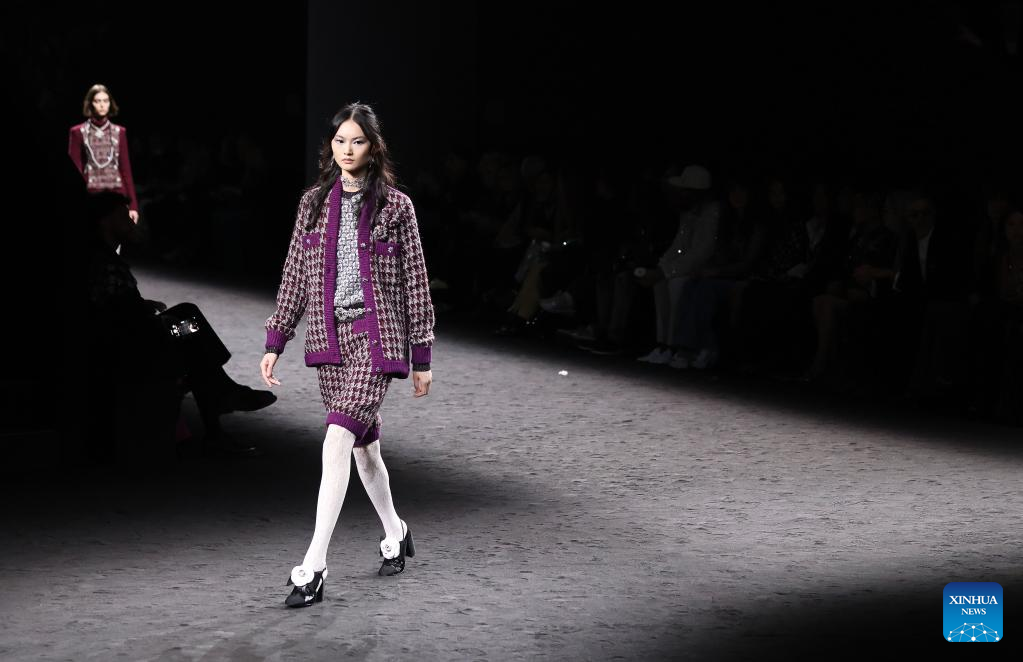 FILE - Models wear creations as part of the Chanel Ready To Wear  Fall/Winter 2022-2023 fashion collection, unveiled during the Fashion Week  in Paris on March 8, 2022. Multibillion dollar French high